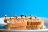 A staged photographic print of mini figures playing soccer on fairy bread by New Zealand artist Adam Popovic, available at The Little Gallery Whangamata